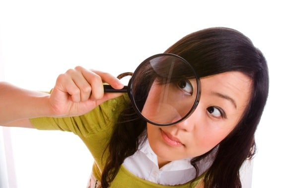 Girl Looking Through a Magnifying Glass - Photo courtesy of &copy;iStockphoto.com/izusek, Image #3551768