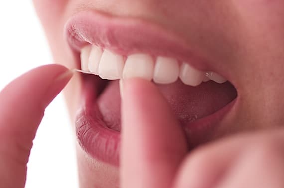 Close Up of Someone Flossing Their Teeth - Photo courtesy of ©iStockphoto.com/apletfx, Image #563258 Close Up of Someone Flossing Their Teeth - Photo courtesy of ©iStockphoto.com/apletfx, Image #563258