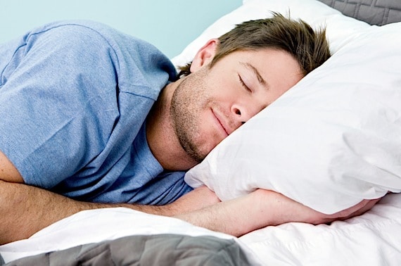 Man comfortably sleeping in his bed - Photo courtesy of ©iStockphoto.com/sswartz, Image #9674561 Man comfortably sleeping in his bed - Photo courtesy of ©iStockphoto.com/sswartz, Image #9674561